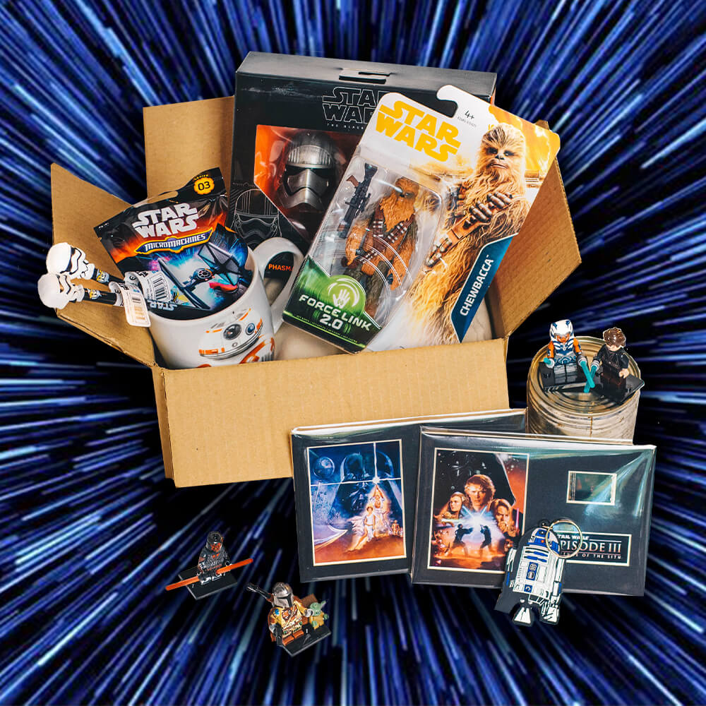 Collection of Star Wars-themed items including a mug, figurines, and photos in a box against a blue starry background. Gifts for Dad.