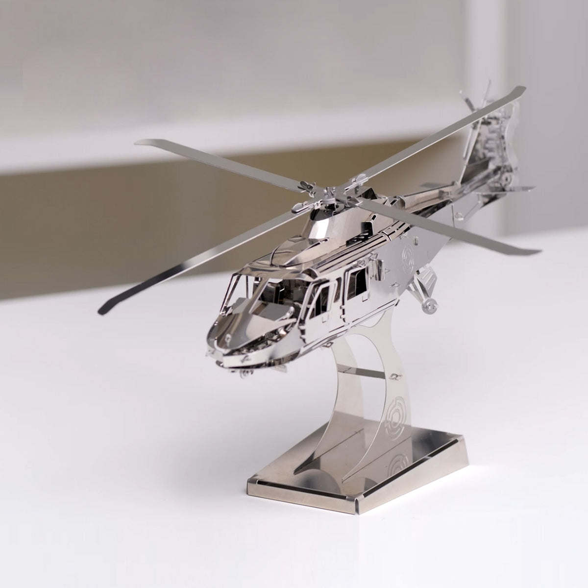 Metallic model of a helicopter on a stand with a white background. gift for dad